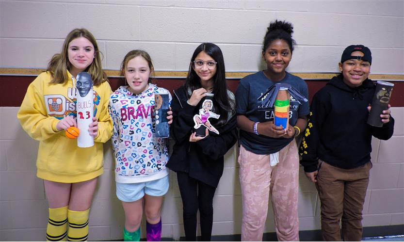 Students hold up Characters in a Can